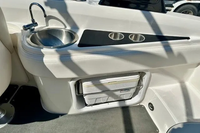 Slide: The Image of Interior of 2013 Sea Ray 240 Sundeck featuring sink and storage area. - 19