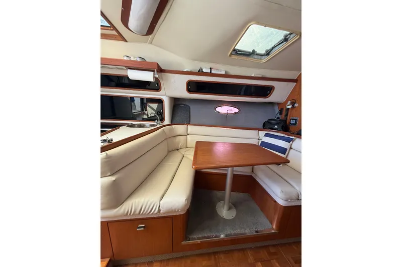 Slide: The Image of Interior of 1990 Tiara Yachts 3300 Open with cozy seating and wooden table. - 15