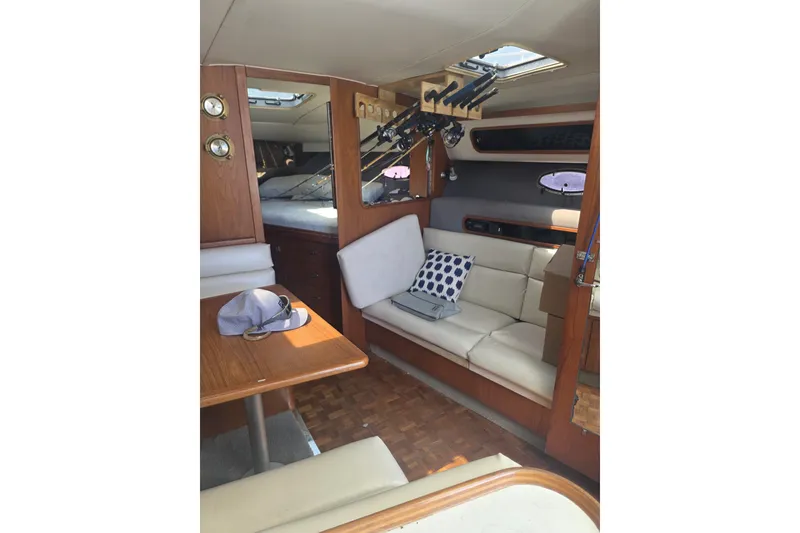Slide: The Image of Interior of a 1990 Tiara 3300 Open yacht with seating and fishing rods. - 6