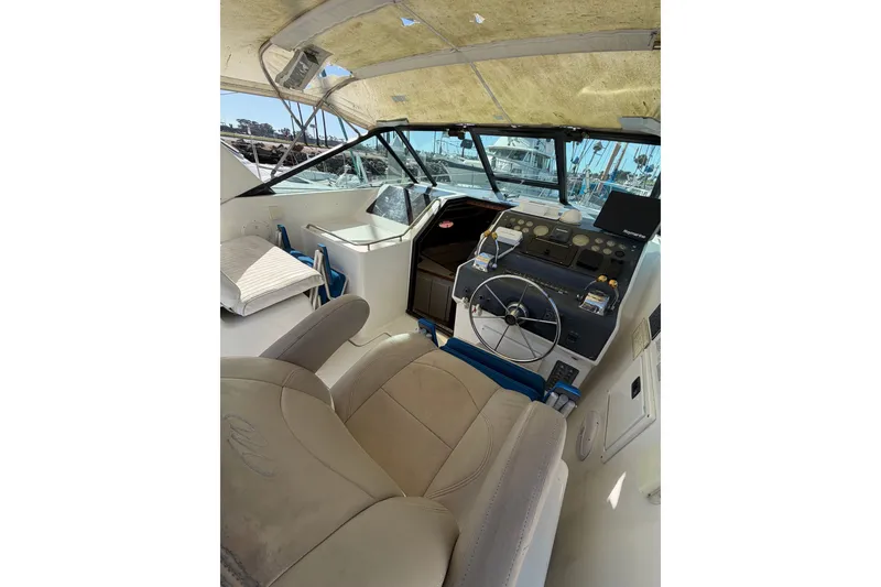 Slide: The Image of 1990 Tiara Yachts 3300 Open cockpit with steering wheel, controls, and seating. - 19