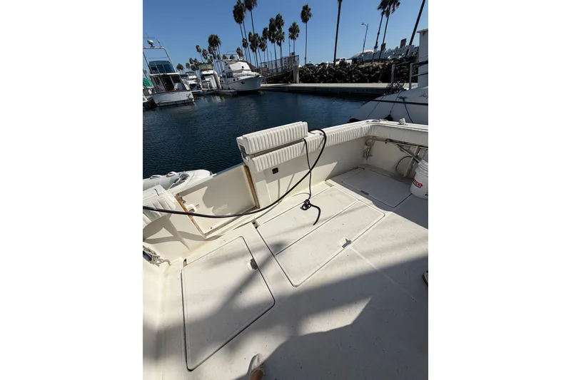 Slide: The Image of 1990 Tiara Yachts 3300 Open boat deck at marina with palm trees. - 20