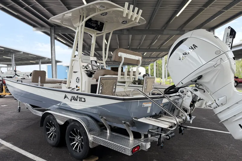 The Image of 2027 Avid 22 Recon boat with Yamaha engine on a trailer in a covered area. - 0