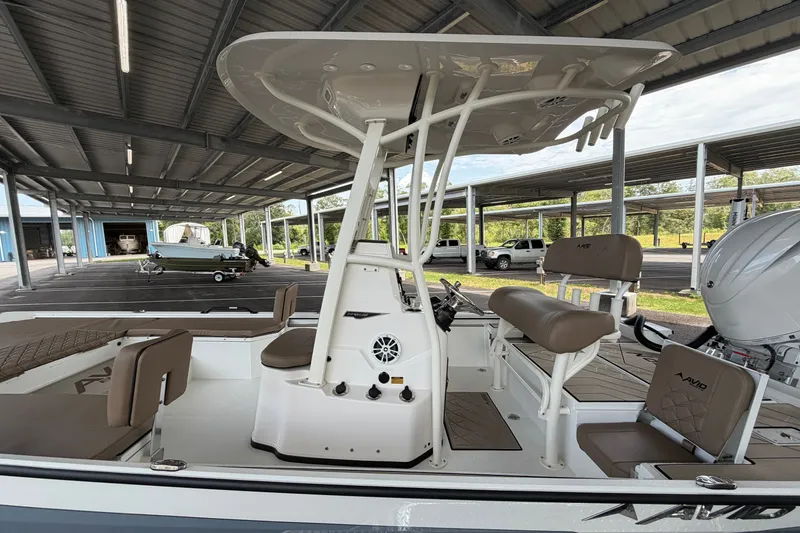 Slide: The Image of 2027 Avid 22 Recon boat with seating and console under a covered dock. - 11