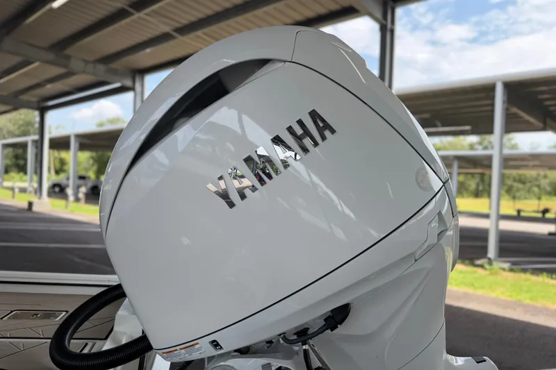 Slide: The Image of White Yamaha outboard motor on Avid 22 Recon, 2027 model, under a covered structure. - 15