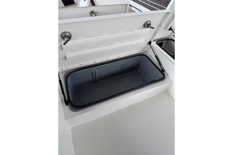 Slide: The Image of Open storage compartment in 2027 Avid 22 Recon boat interior. - 32