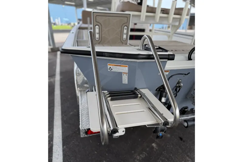 Slide: The Image of Avid 22 Recon 2027 boat with stainless steel swim ladder and deck details. - 13