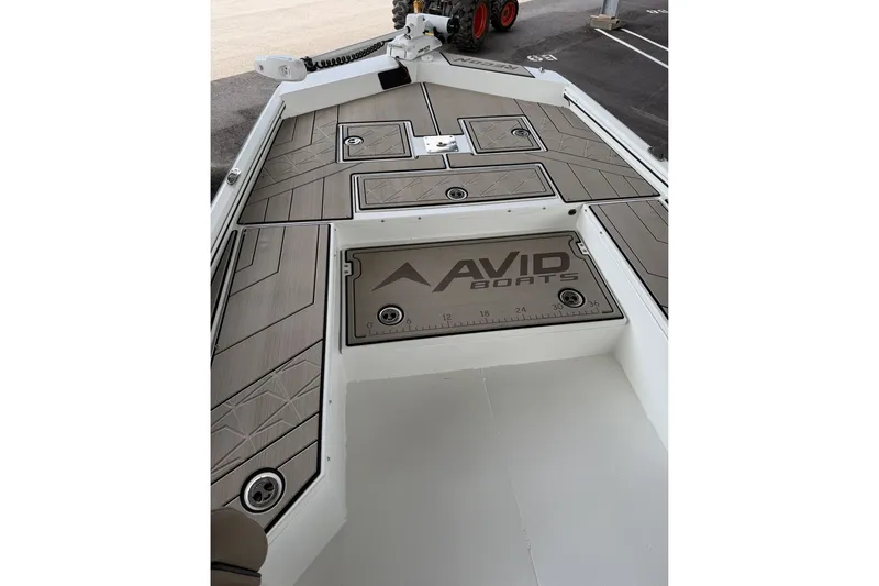 Slide: The Image of 2027 Avid 22 Recon boat deck with sleek design and storage compartments. - 30