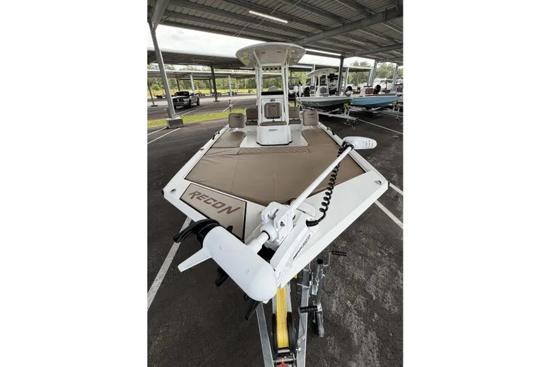 Slide: The Image of 2027 Avid 22 Recon boat in parking area, featuring spacious deck and modern design. - 3