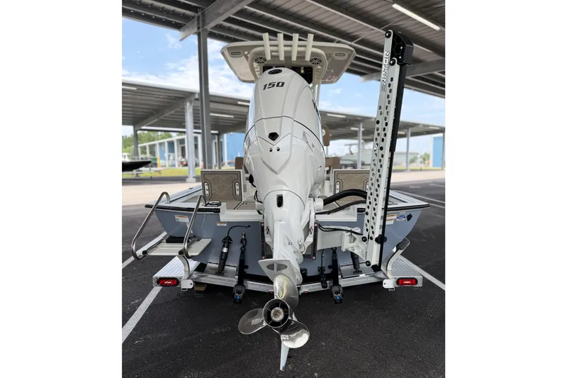 Slide: The Image of Avid 22 Recon 2027 boat with powerful outboard motor in covered parking area. - 16