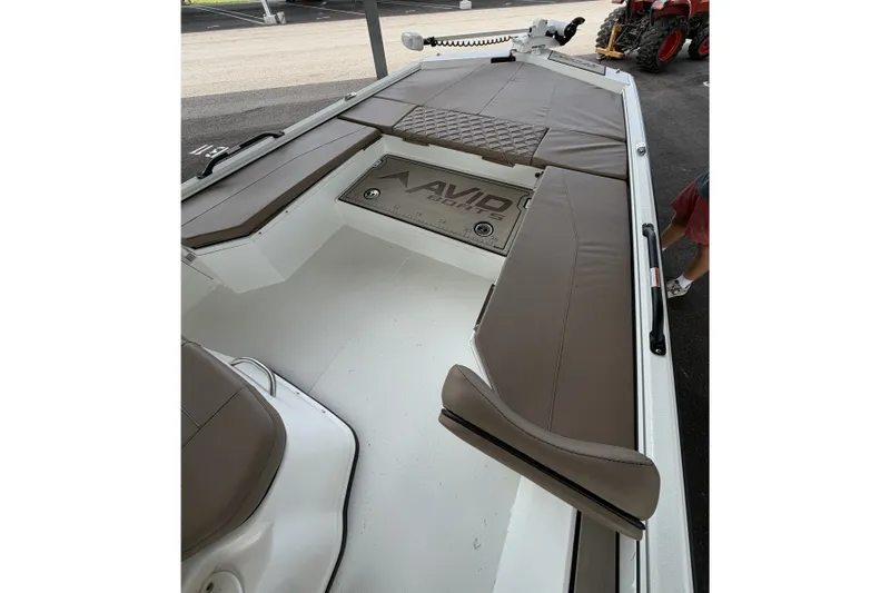 Slide: The Image of Interior view of 2027 Avid 22 Recon boat with cushioned seating and storage. - 28