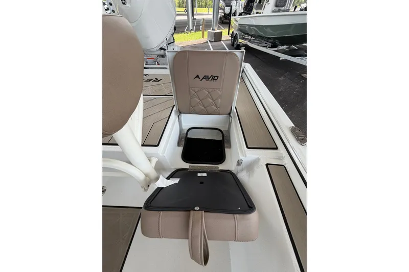 Slide: The Image of 2027 Avid 22 Recon boat seat with storage compartment, beige upholstery. - 25