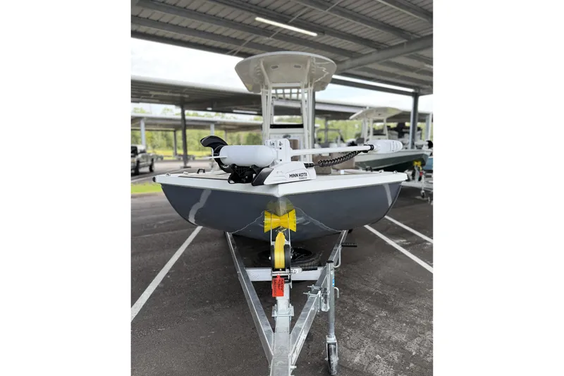 Slide: The Image of Avid 22 Recon 2027 boat on trailer in covered parking area. - 4