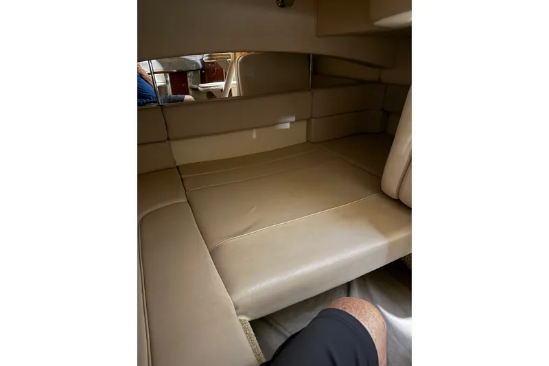 Slide: The Image of Interior cabin of 2006 Sea Ray 300 Sundancer with beige leather seating. - 13