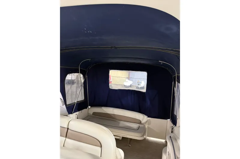 Slide: The Image of Interior view of 2006 Sea Ray 300 Sundancer with blue canopy and seating. - 16