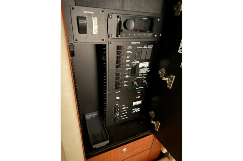 Slide: The Image of Electrical panel inside 2006 Sea Ray 300 Sundancer boat, featuring control switches and gauges. - 18
