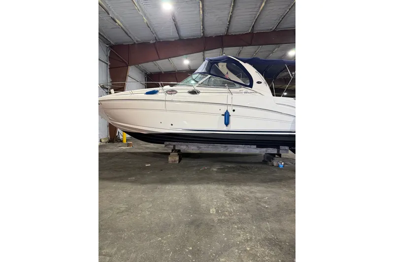 The Image of 2006 Sea Ray 300 Sundancer boat in indoor storage, side view. - 0