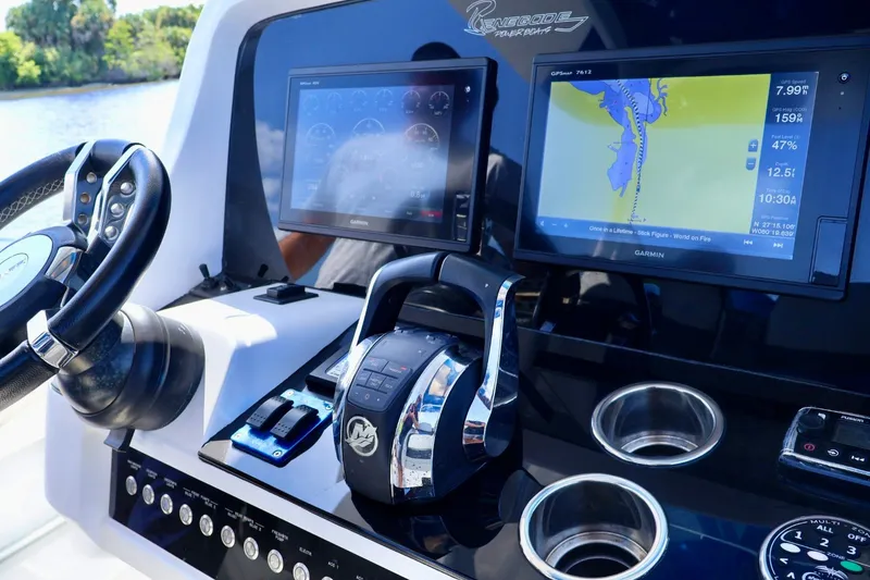 Slide: The Image of Cockpit of 2018 Renegade 33 Open boat with navigation screens and controls. - 40
