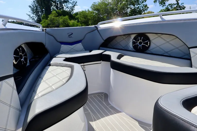 Slide: The Image of The image shows the bow area of a 2018 Renegade 33 Open with cushioned seating and speakers. - 30