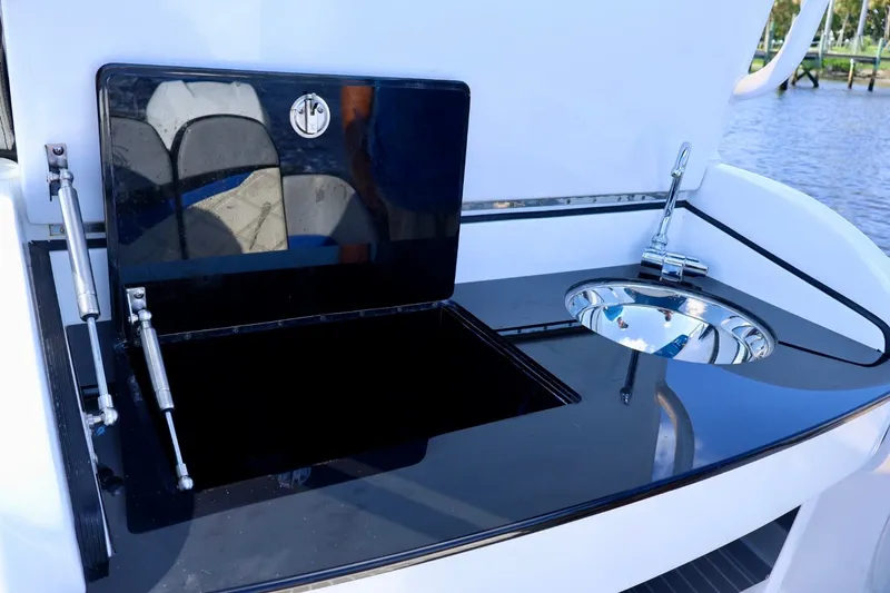 Slide: The Image of 2018 Renegade 33 Open boat kitchenette with sink and storage compartment. - 35