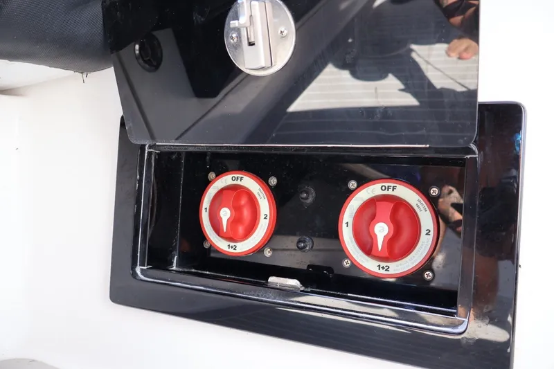 Slide: The Image of Battery switches on a 2018 Renegade 33 Open boat, featuring dual red dials. - 39