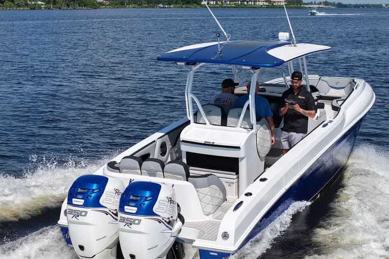 Slide: The Image of 2018 Renegade 33 Open boat cruising on water with twin Mercury 350R engines. - 26