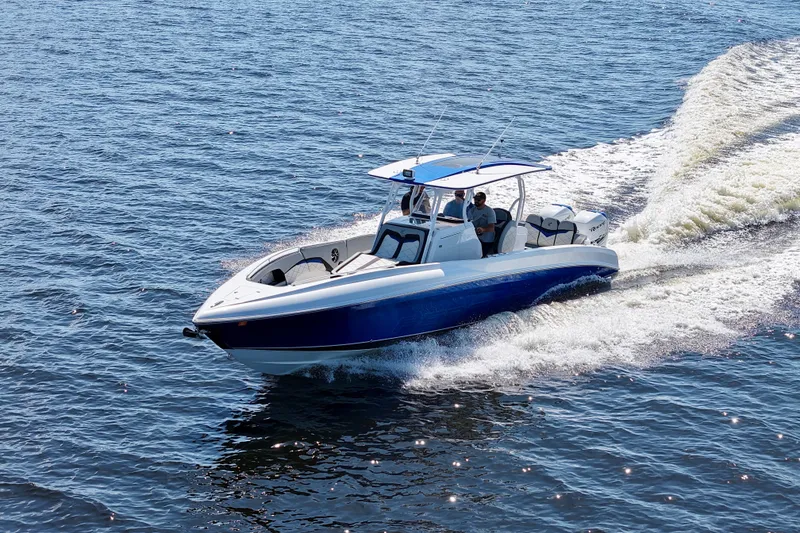 Slide: The Image of 2018 Renegade 33 Open boat cruising on open water, showcasing sleek design and powerful performance. - 25