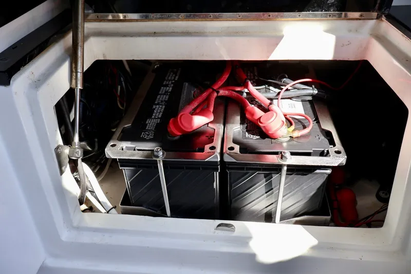 Slide: The Image of Battery compartment of 2018 Renegade 33 Open boat with visible wiring connections. - 46