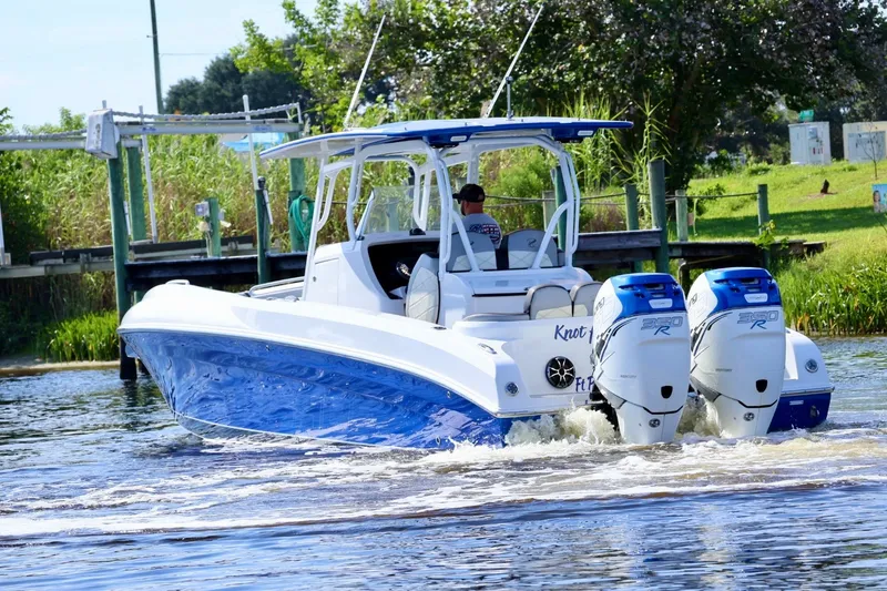 The Image of 2018 Renegade 33 Open boat with dual engines cruising on a sunny day. - 1