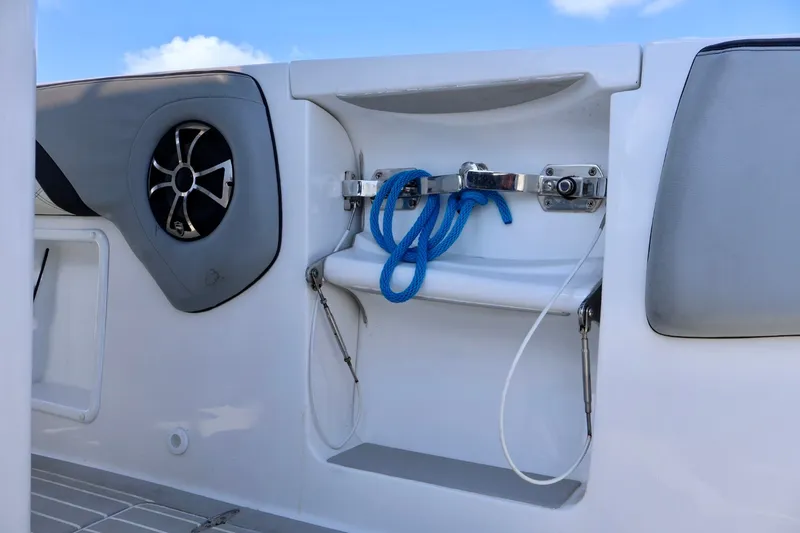 Slide: The Image of 2018 Renegade 33 Open boat interior with speaker and blue rope storage. - 37