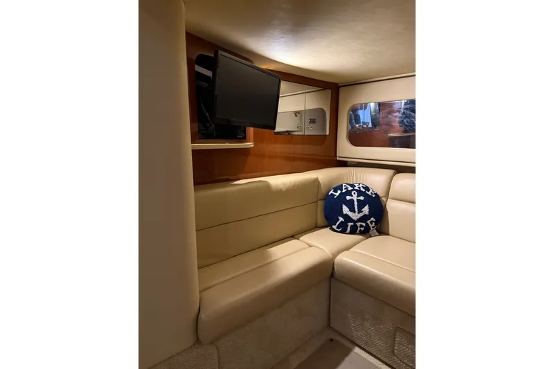 Slide: The Image of Interior of 2002 Sea Ray 410 Sundancer with beige seating and nautical decor. - 28