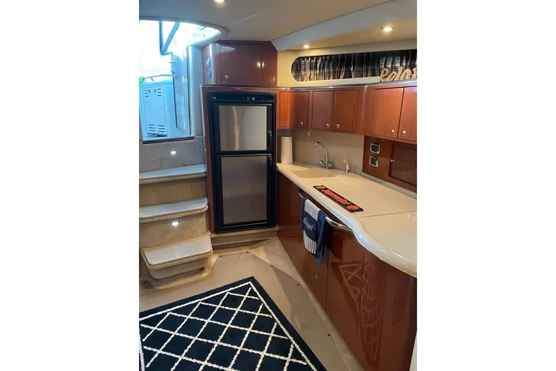 Slide: The Image of Luxurious 2002 Sea Ray 410 Sundancer yacht interior with modern kitchen and elegant cabinetry. - 21