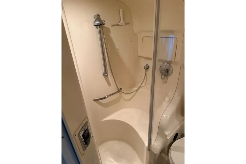Slide: The Image of Shower area in 2002 Sea Ray 410 Sundancer yacht, featuring a handheld showerhead. - 26
