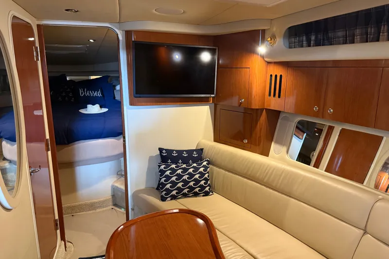 Slide: The Image of Luxurious interior of 2002 Sea Ray 410 Sundancer yacht with cozy seating and elegant wood finishes. - 23
