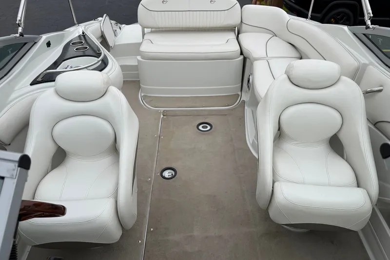Slide: The Image of 2007 Crownline 240 EX boat interior with white leather seating and modern design. - 13