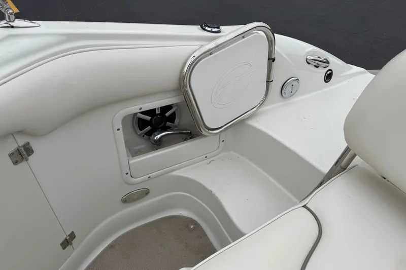 Slide: The Image of Interior view of a 2007 Crownline 240 EX boat, featuring seating and storage compartment. - 21
