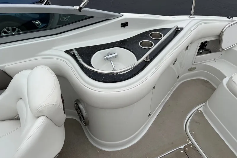Slide: The Image of 2007 Crownline 240 EX boat interior with sink and cup holders. - 14