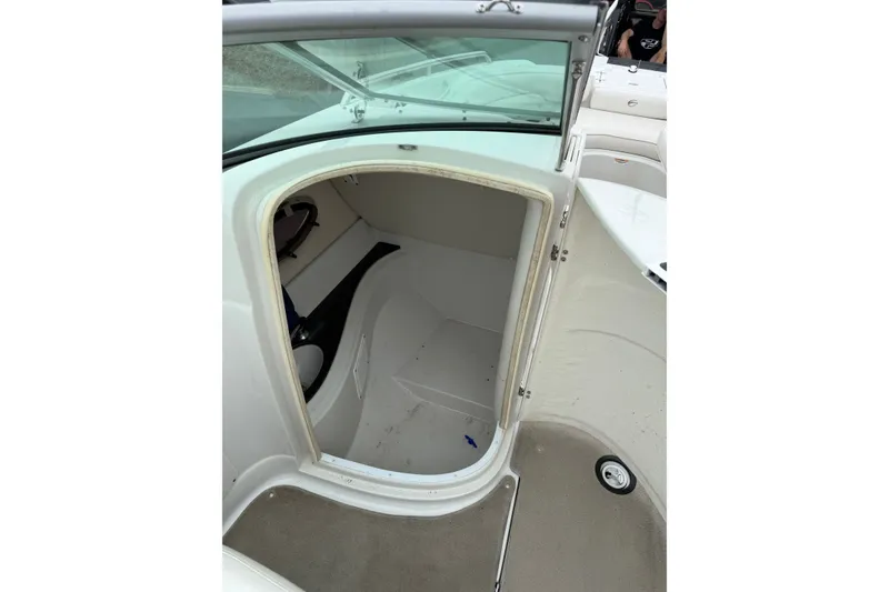 Slide: The Image of 2007 Crownline 240 EX boat interior with open storage compartment. - 17