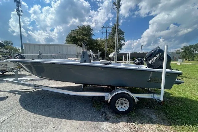 The Image of 2025 Carolina Skiff EV218 Sea Skiff on trailer, parked outdoors under a partly cloudy sky. - 1