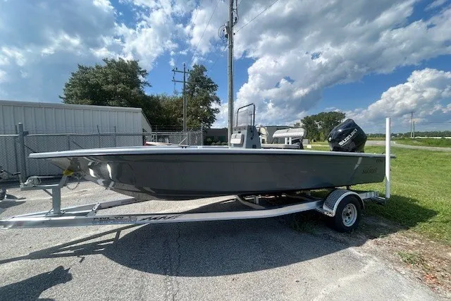 Slide: The Image of 2025 Carolina Skiff EV218 Sea Skiff on trailer, parked outdoors under a partly cloudy sky. - 3