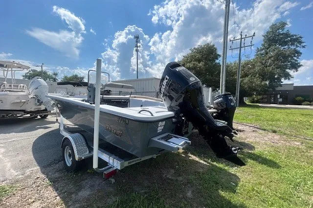 Slide: The Image of 2025 Carolina Skiff EV218 Sea Skiff on trailer, parked outdoors under a blue sky. - 5
