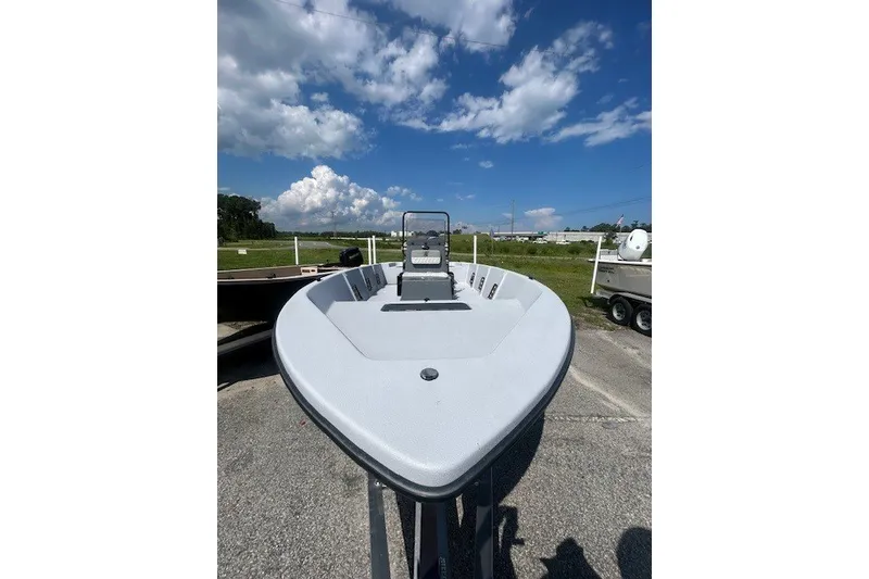 Slide: The Image of 2025 Carolina Skiff EV218 Sea Skiff on display under a clear blue sky. - 4