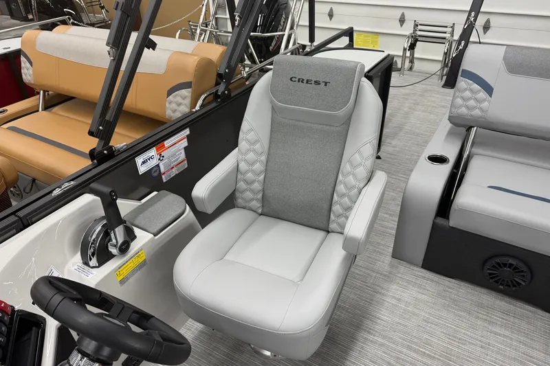 Slide: The Image of Captain's chair in 2027 Crest Conquest 230 SLSC boat, featuring luxurious upholstery and modern design. - 14