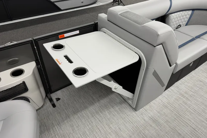Slide: The Image of 2027 Crest Conquest 230 SLSC boat interior with foldable table and cup holders. - 9