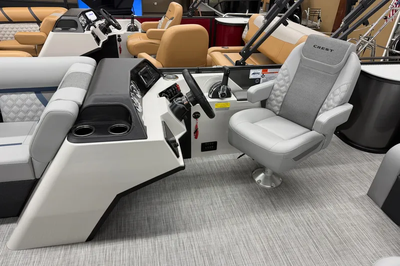 Slide: The Image of Luxurious helm seating in 2027 Crest Conquest 230 SLSC boat, featuring modern design and controls. - 5
