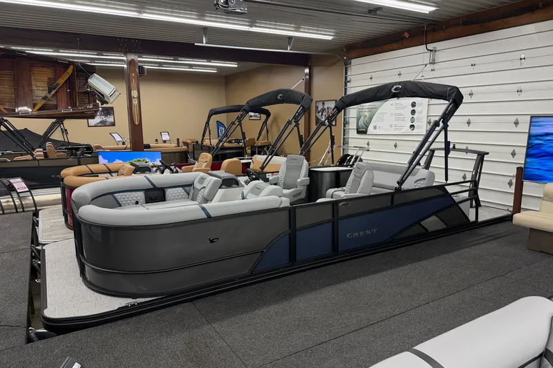 The Image of 2027 Crest Conquest 230 SLSC pontoon boat displayed in a showroom. - 0