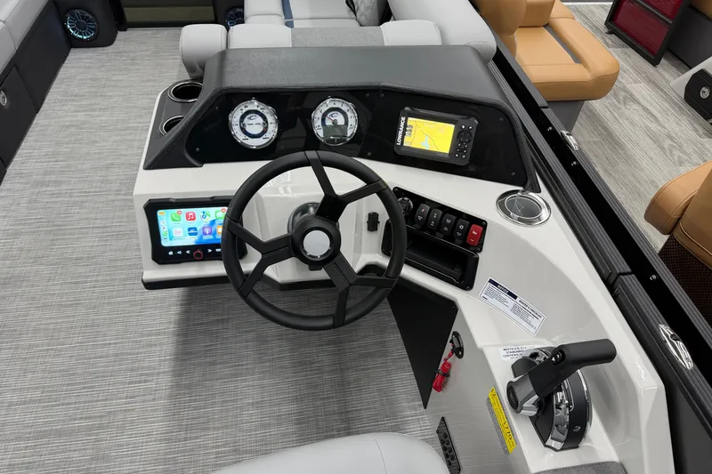 Slide: The Image of 2027 Crest Conquest 230 SLSC boat dashboard with steering wheel, gauges, and navigation display. - 10