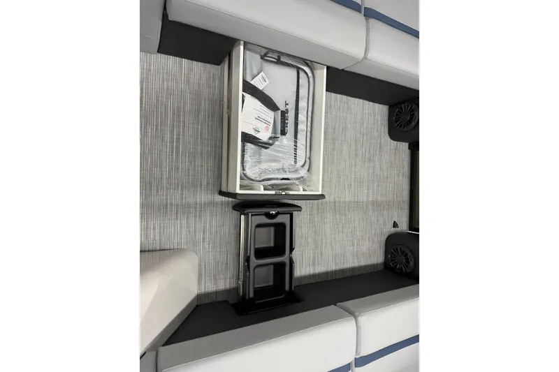 Slide: The Image of Interior of 2027 Crest Conquest 230 SLSC boat with storage compartment and speakers. - 8
