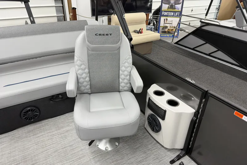Slide: The Image of Luxury seating on 2027 Crest Conquest 230 SLSC pontoon boat, featuring cup holders and speaker. - 4
