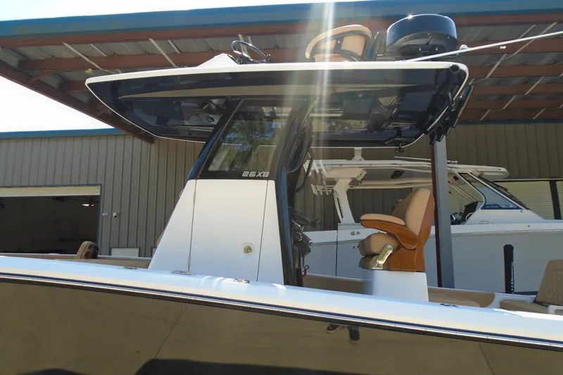Slide: The Image of 2027 STRIKING BOATS 26XB under a metal canopy, showcasing sleek design and modern features. - 18