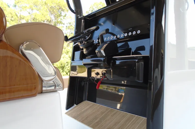 Slide: The Image of 2027 STRIKING BOATS 26XB helm with modern controls and sleek design. - 10